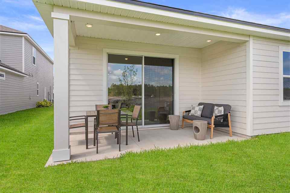 Laurel II Model Home Covered Patio with Table and Chairs at Camden Woods in Kingsland, GA