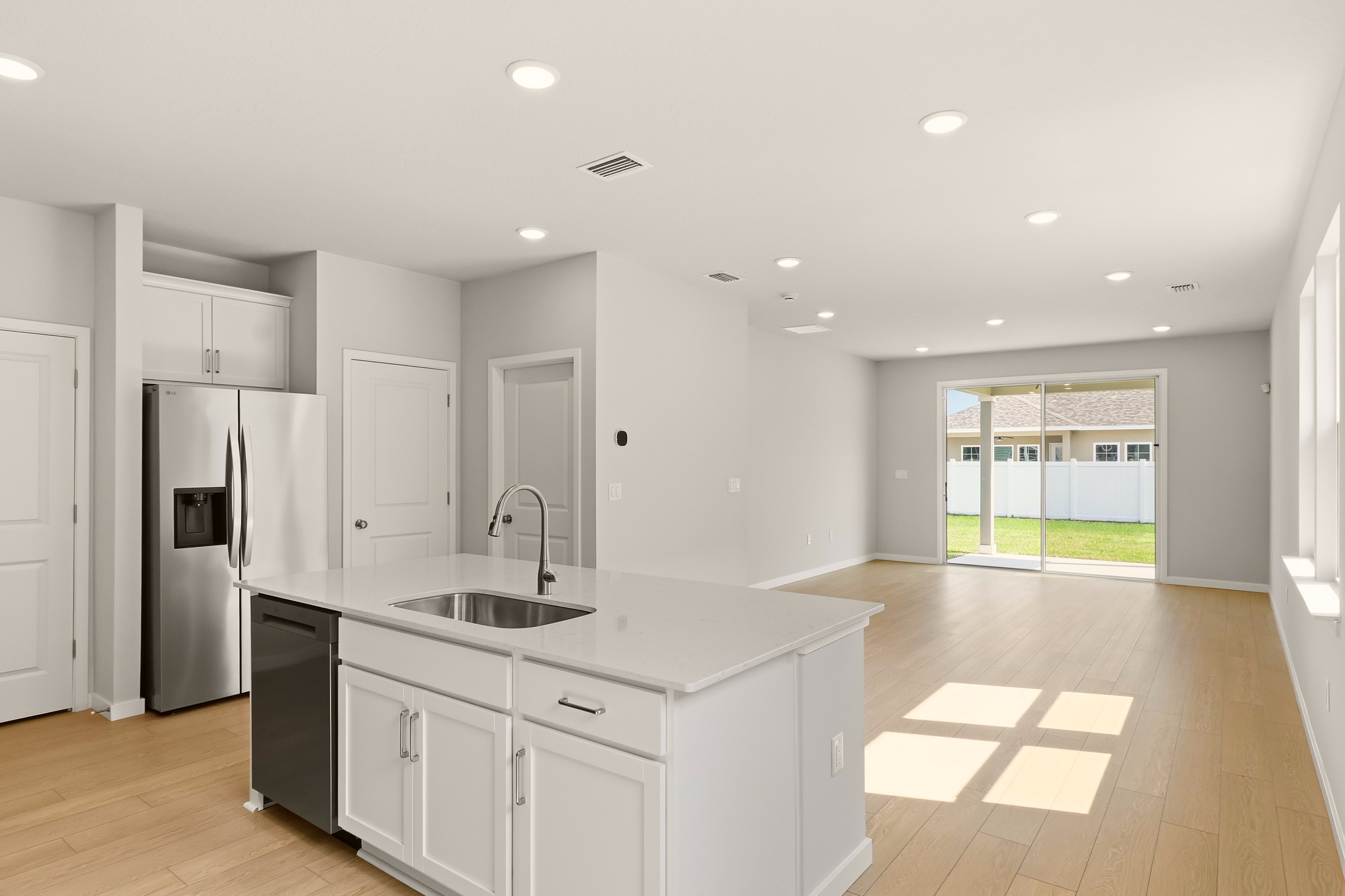 A kitchen with white cabinets.