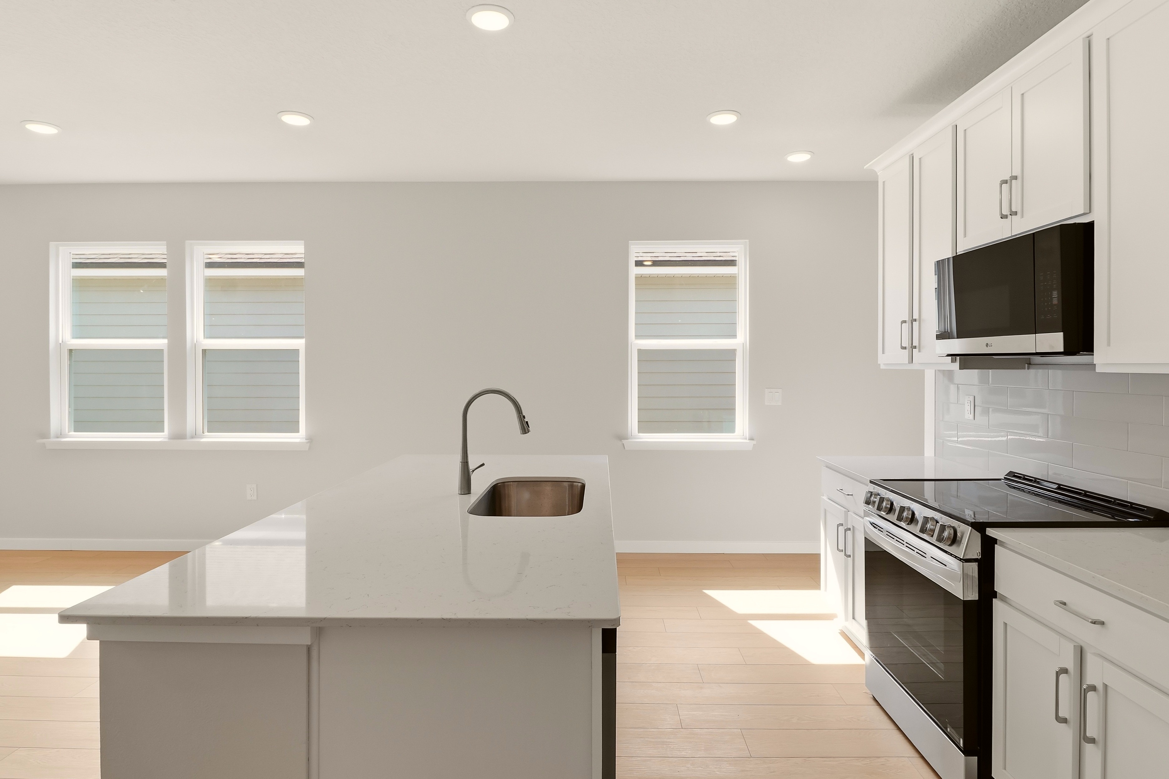 A kitchen with white cabinets.