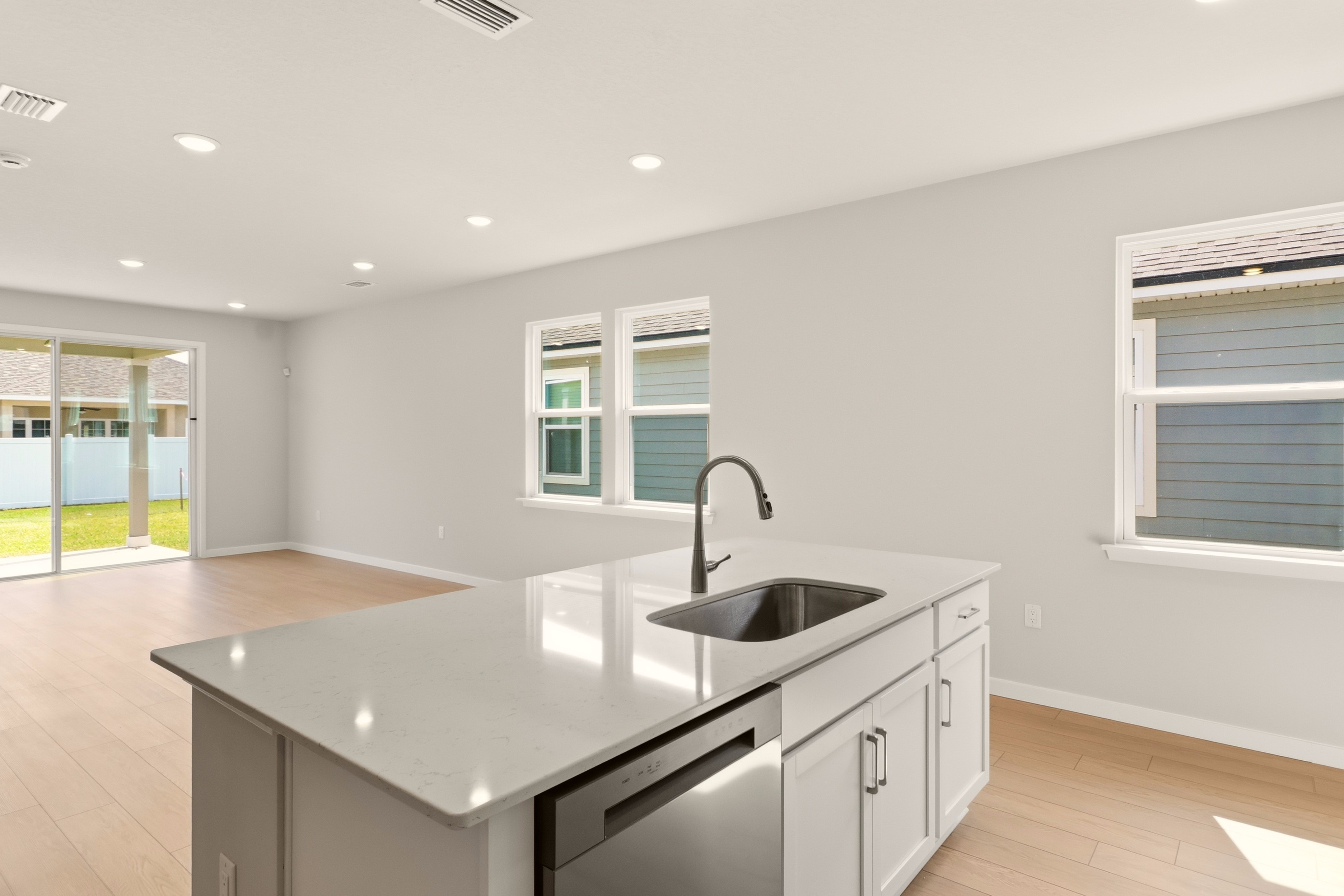 A kitchen with white cabinets.