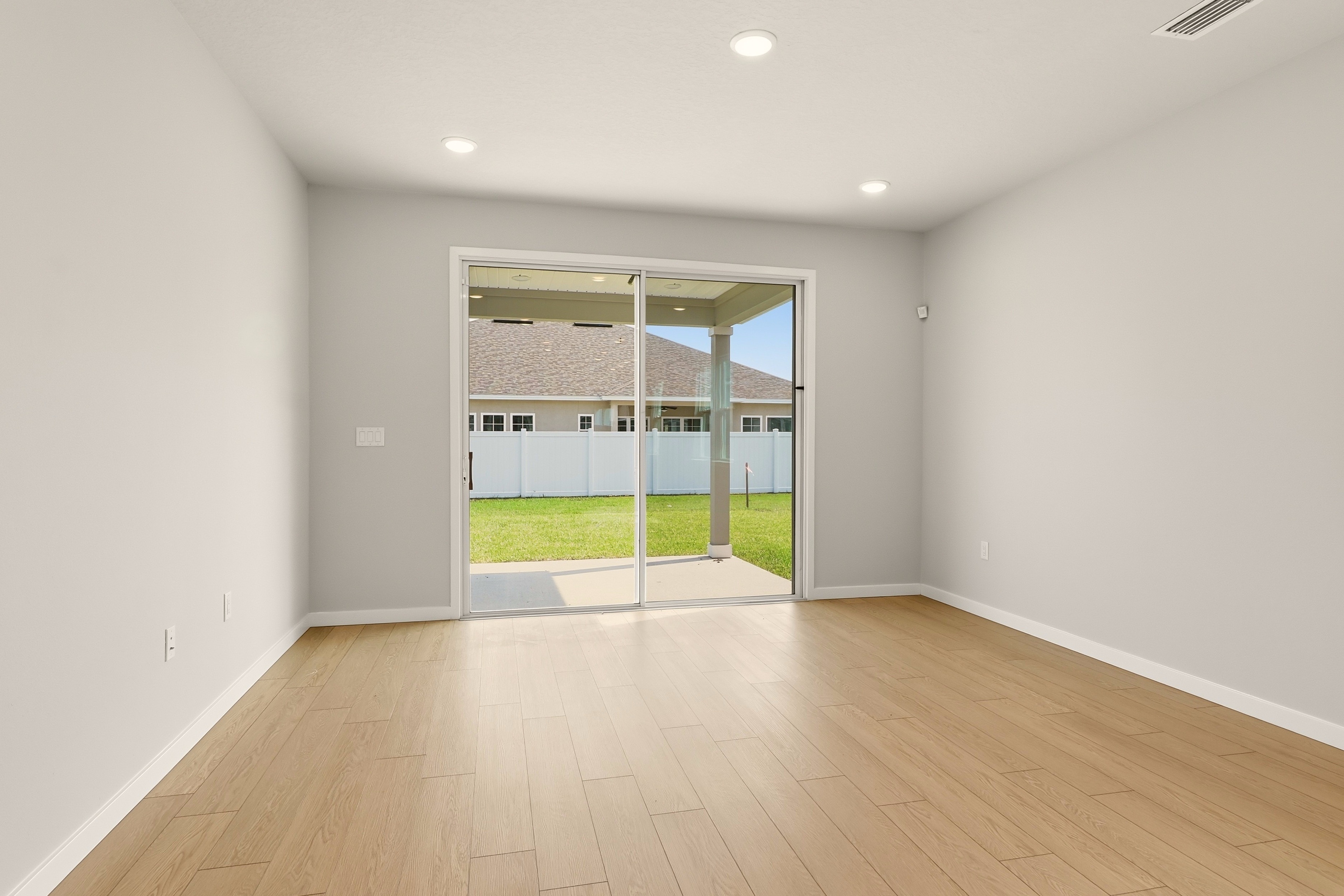 A room with a wood floor and a glass door.