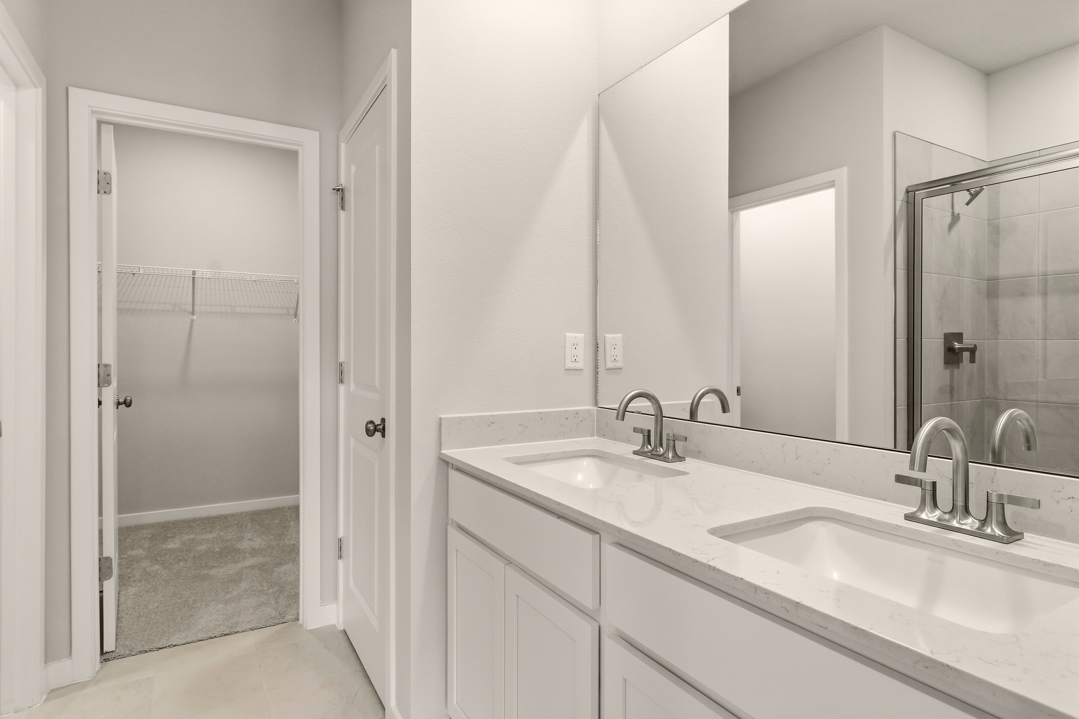 A bathroom with a sink and a shower.