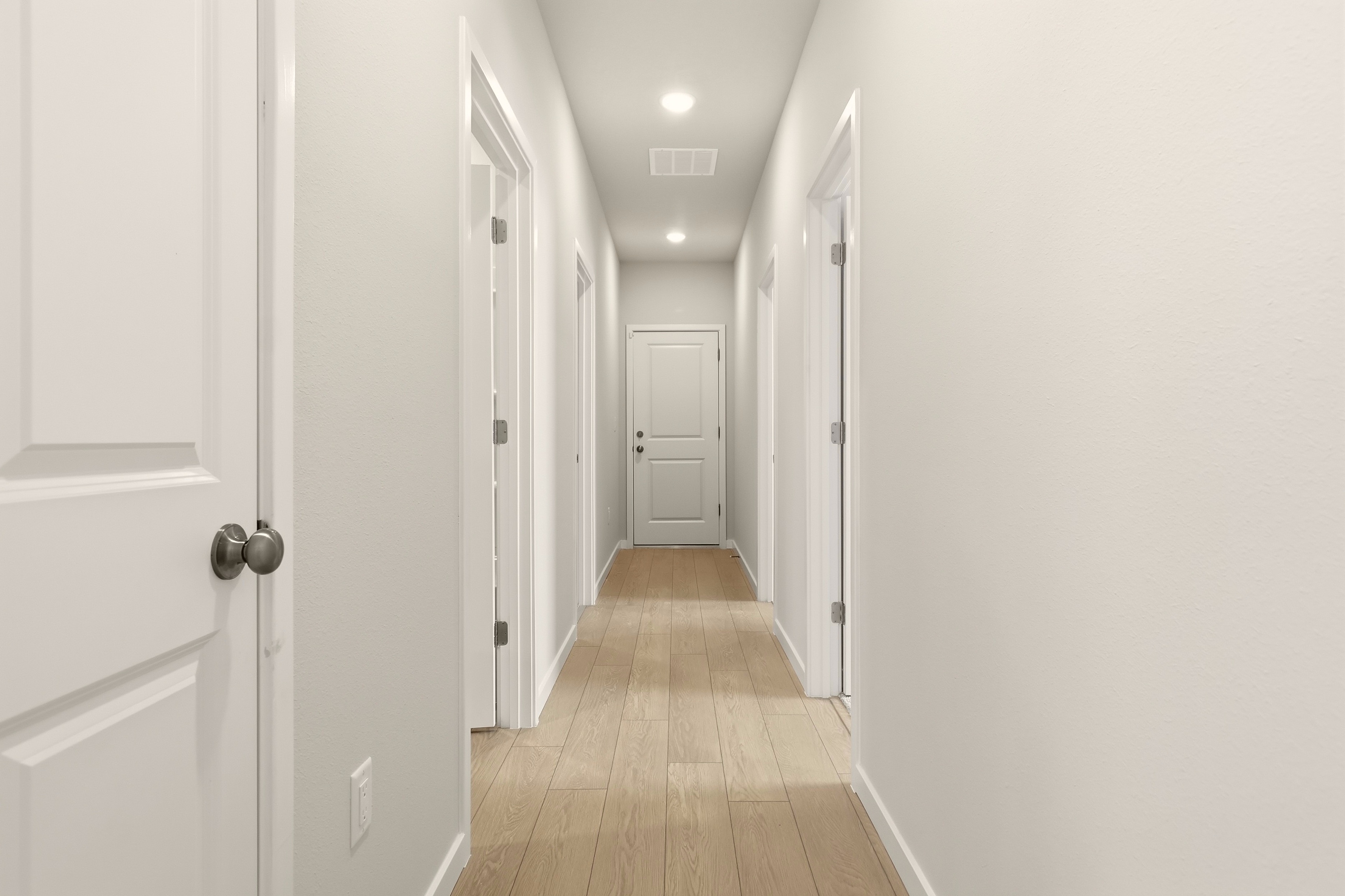 A hallway with white doors.