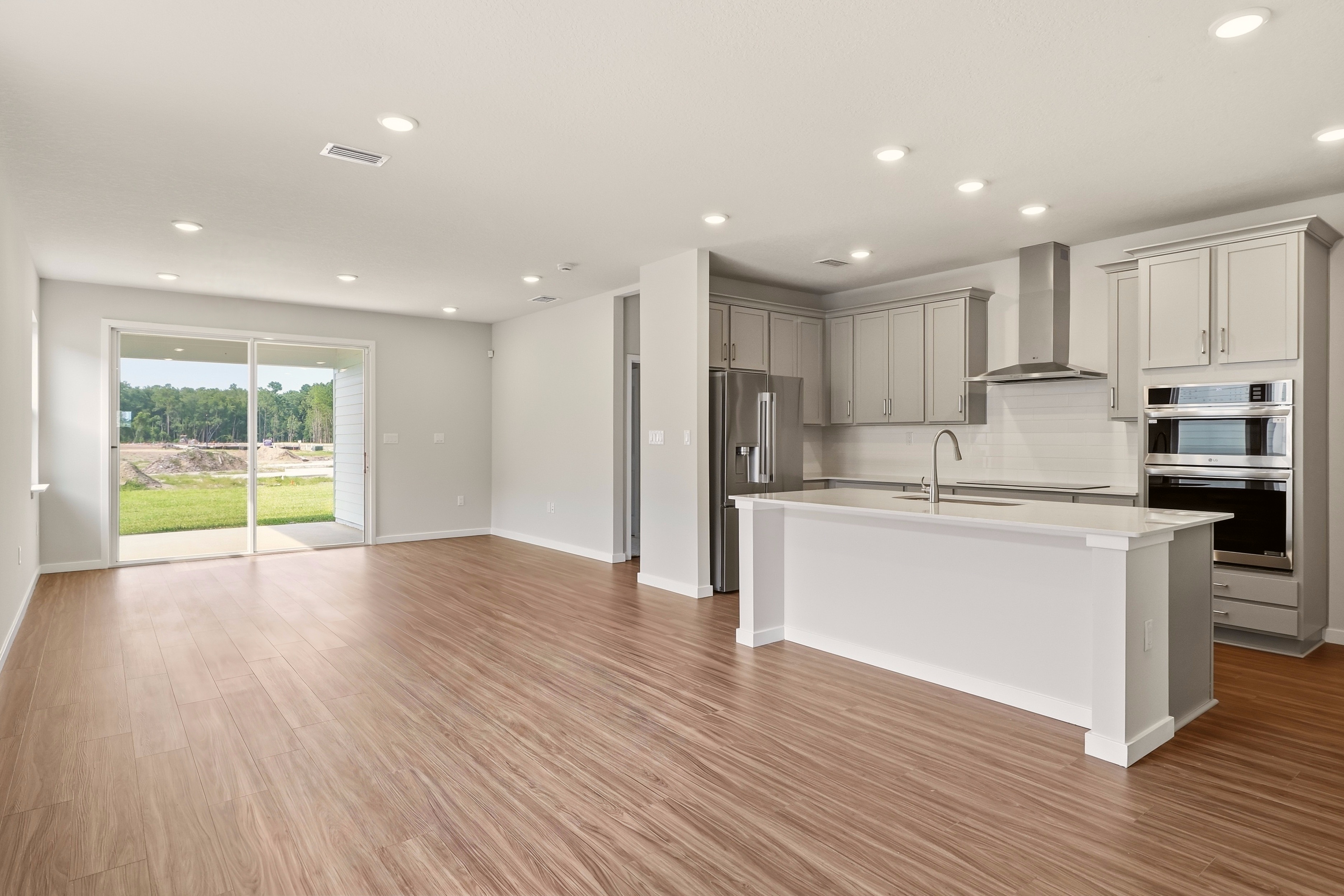 A kitchen with white cabinets.