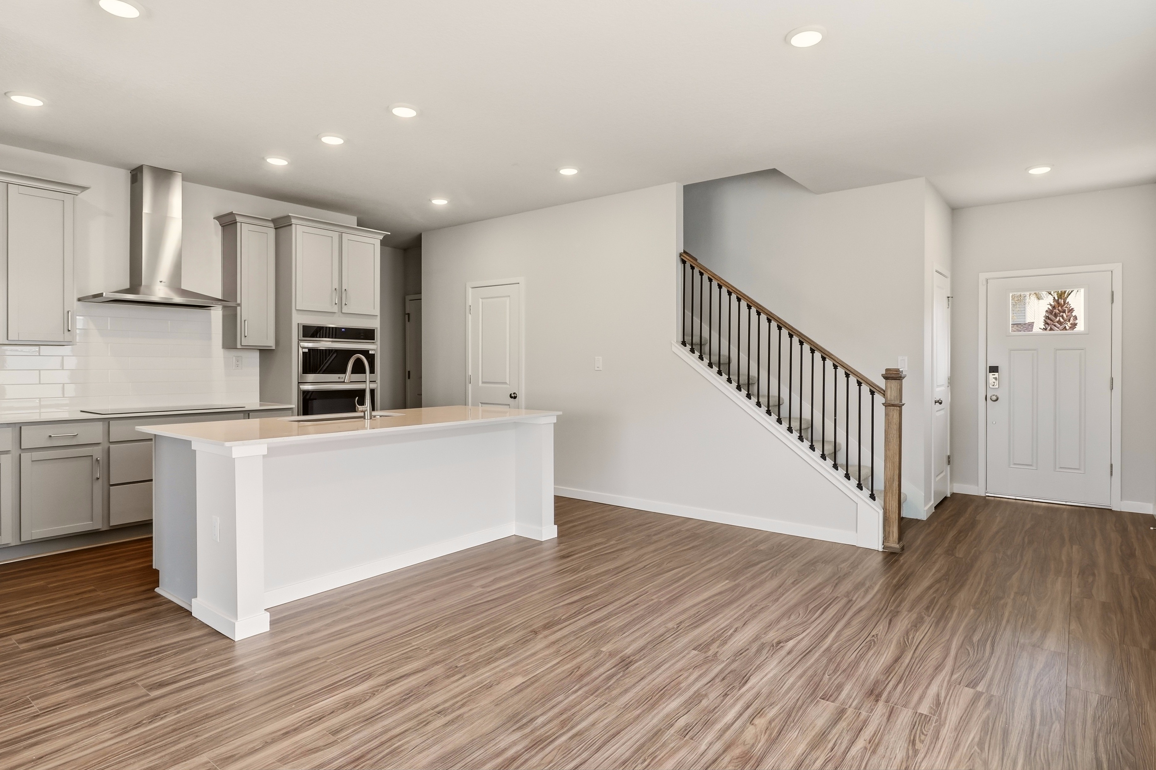 A kitchen with white cabinets.