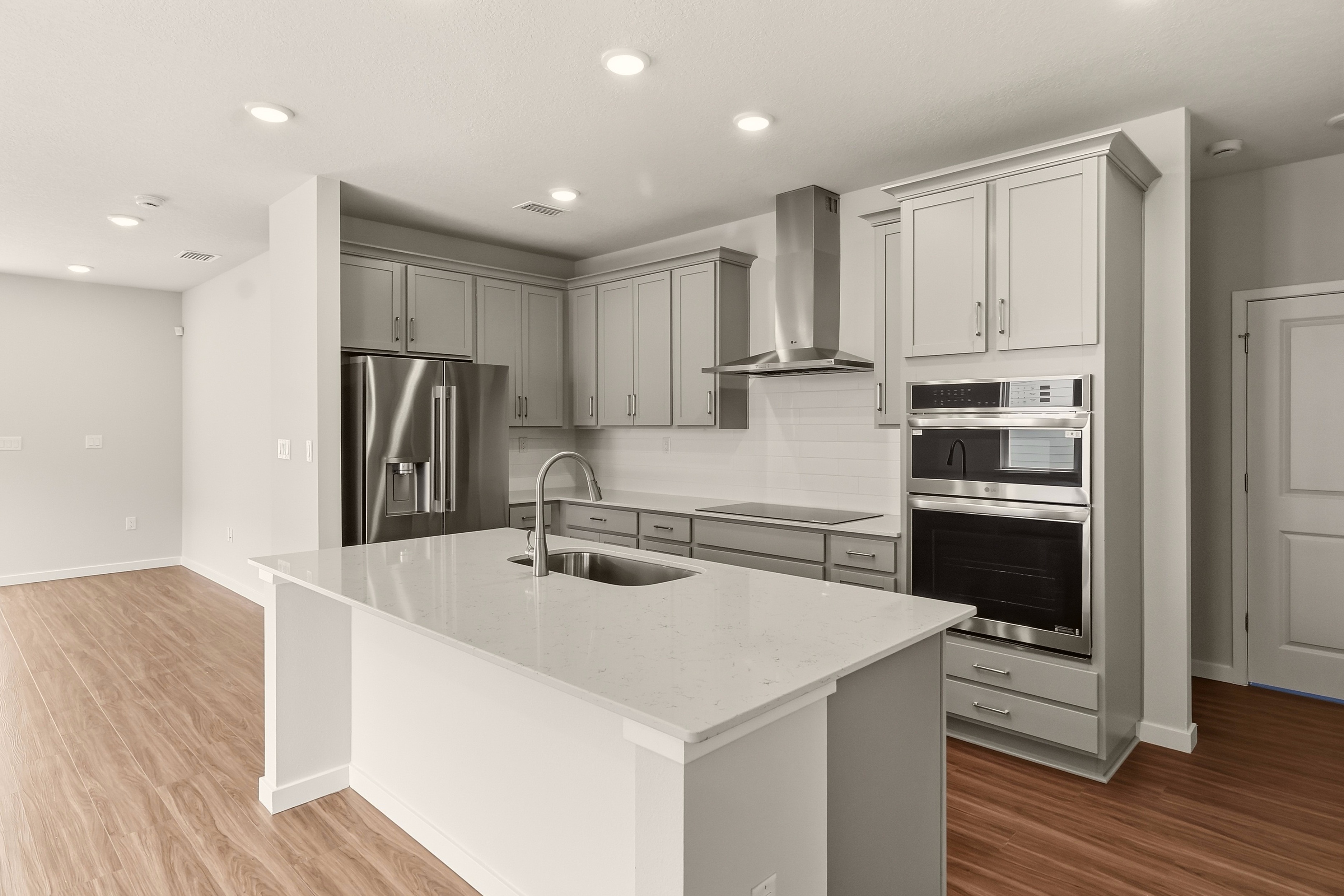 A kitchen with white cabinets.