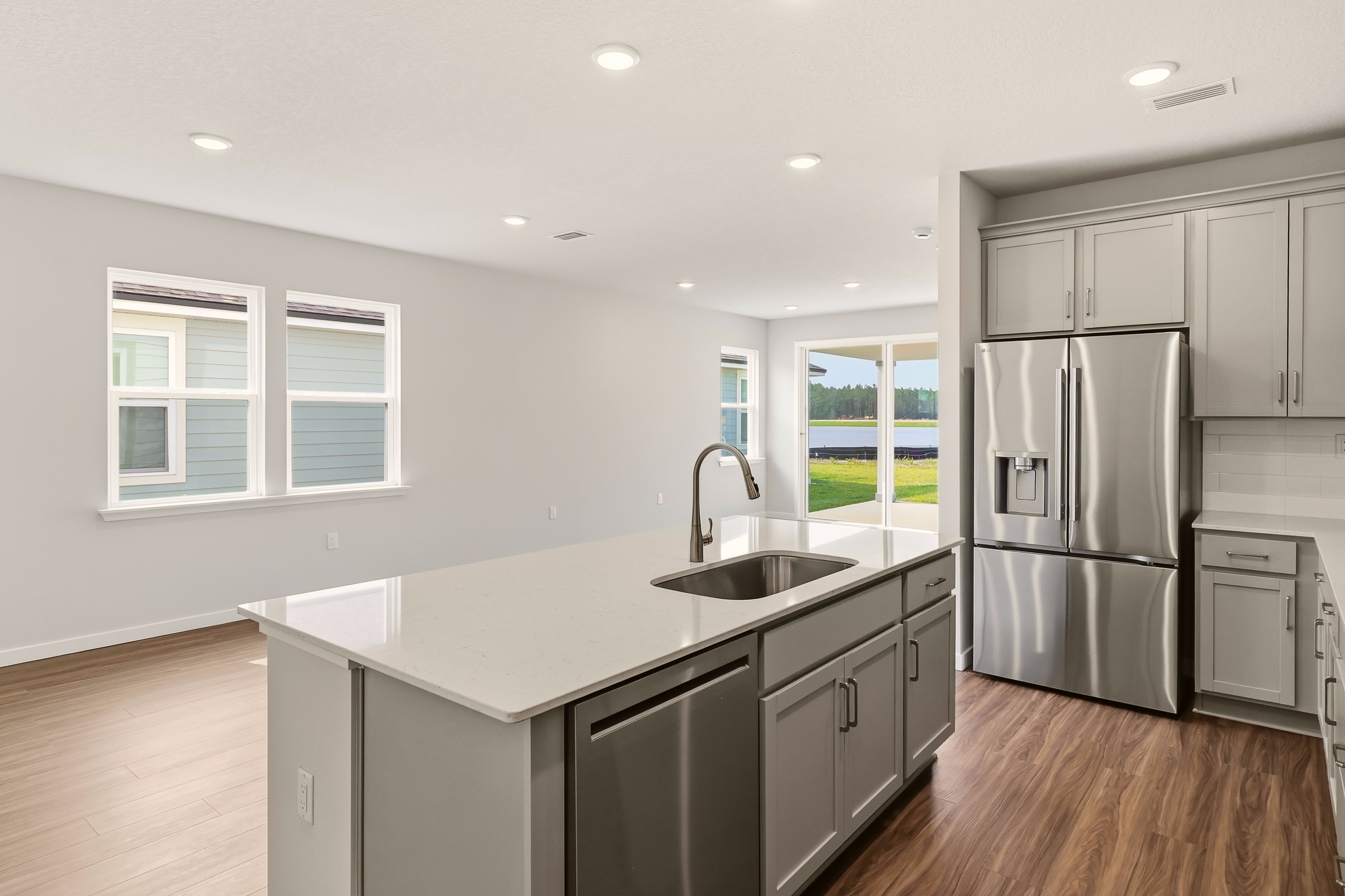 A kitchen with a stainless steel refrigerator.