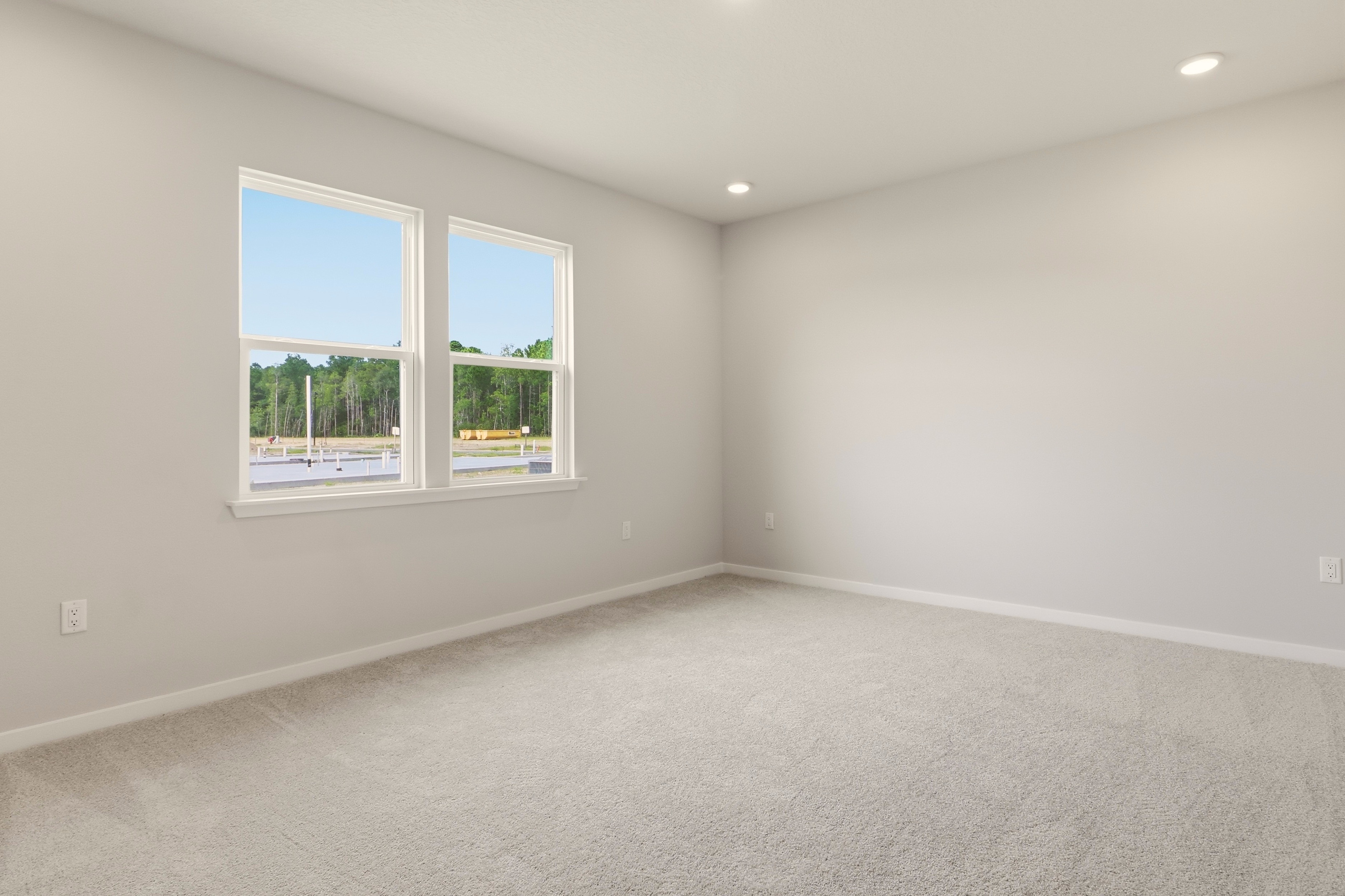 A room with windows and a carpet.