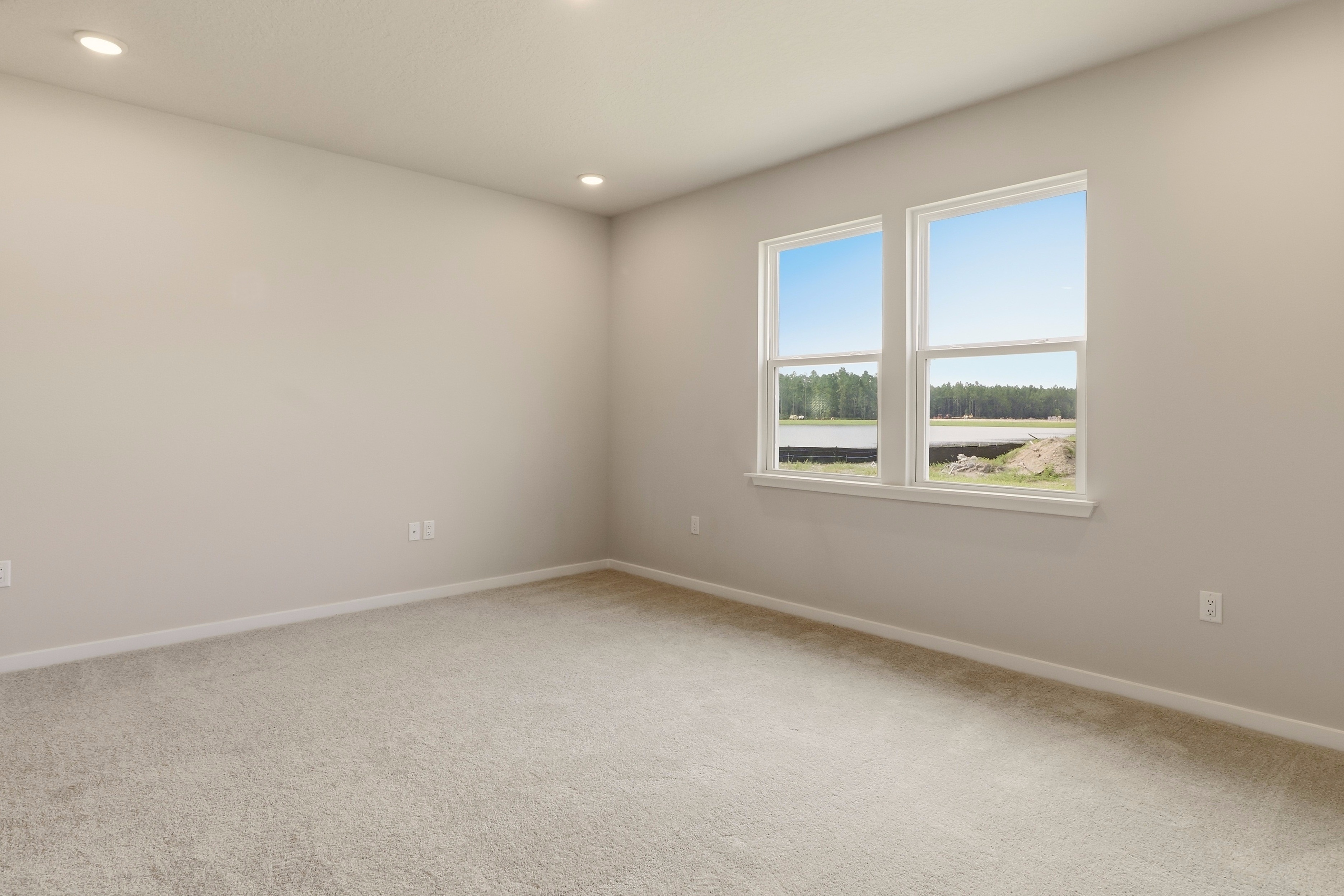 A room with a window and a carpet.