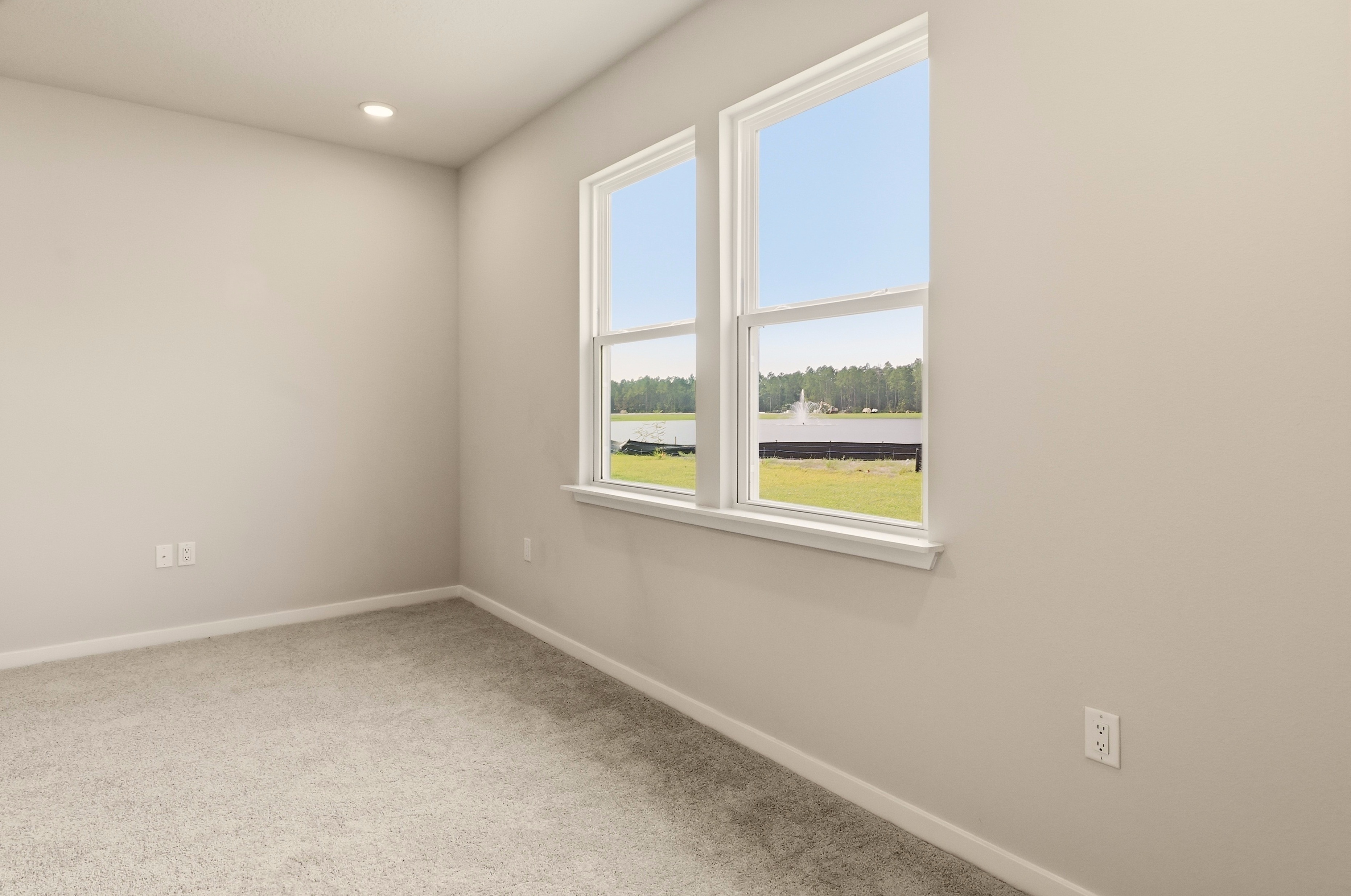 A room with a window and a carpet.