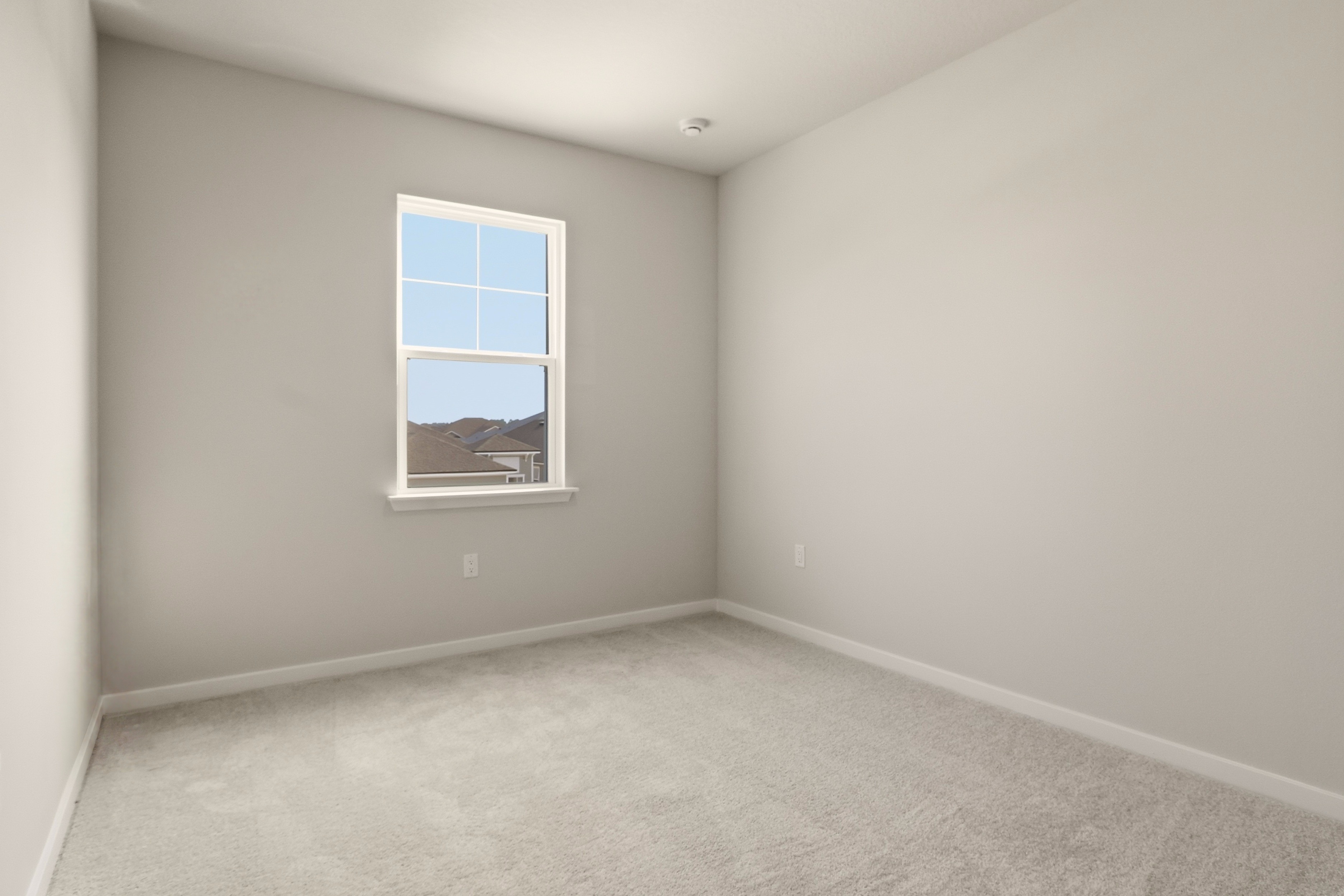 A room with a window and a carpet.
