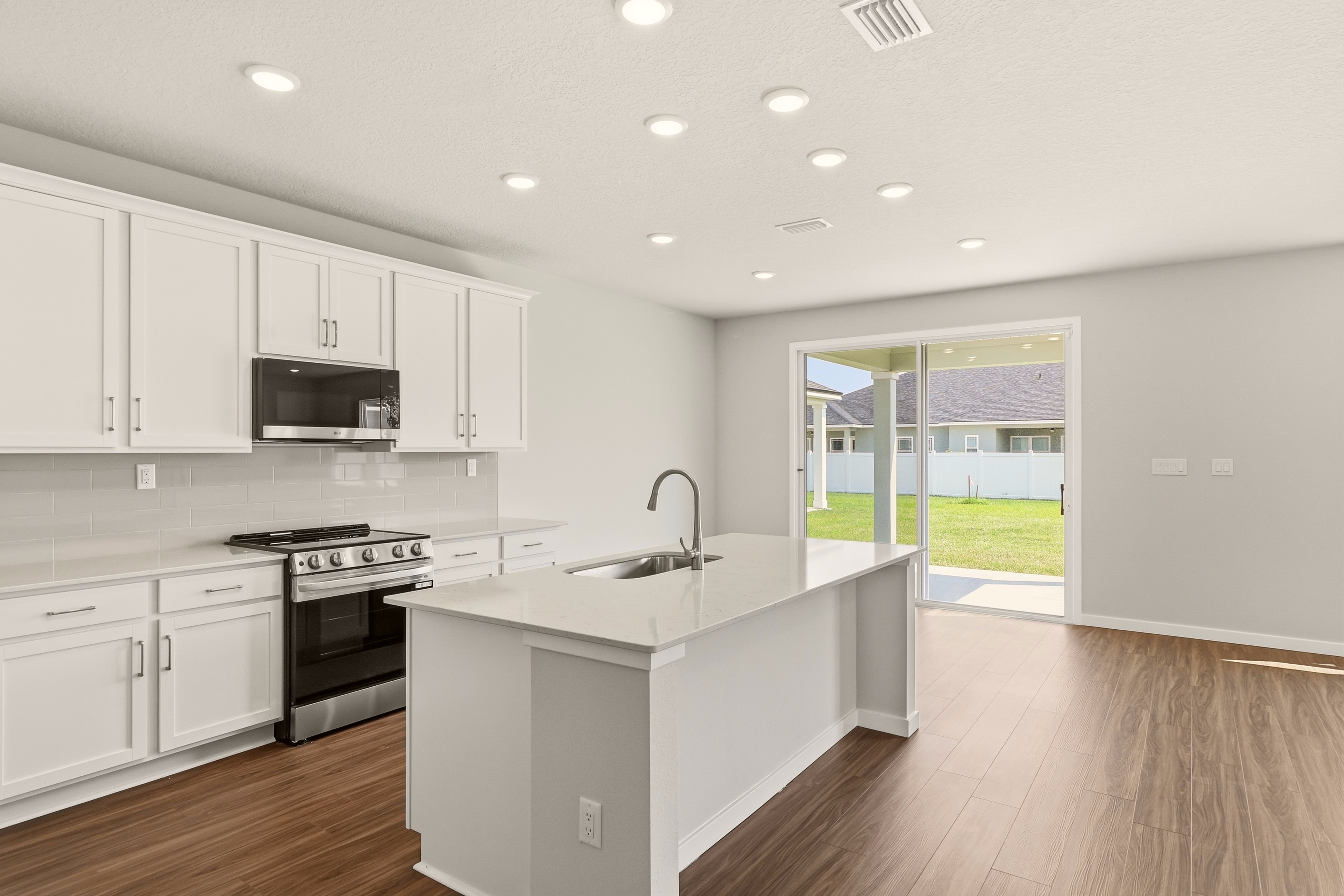 A kitchen with white cabinets.