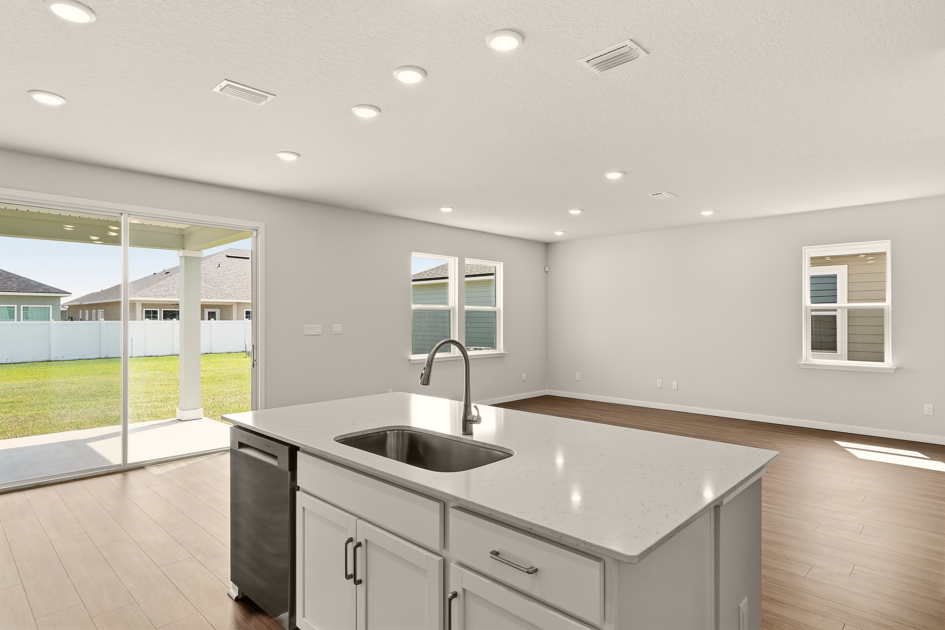 A kitchen with a large glass door.