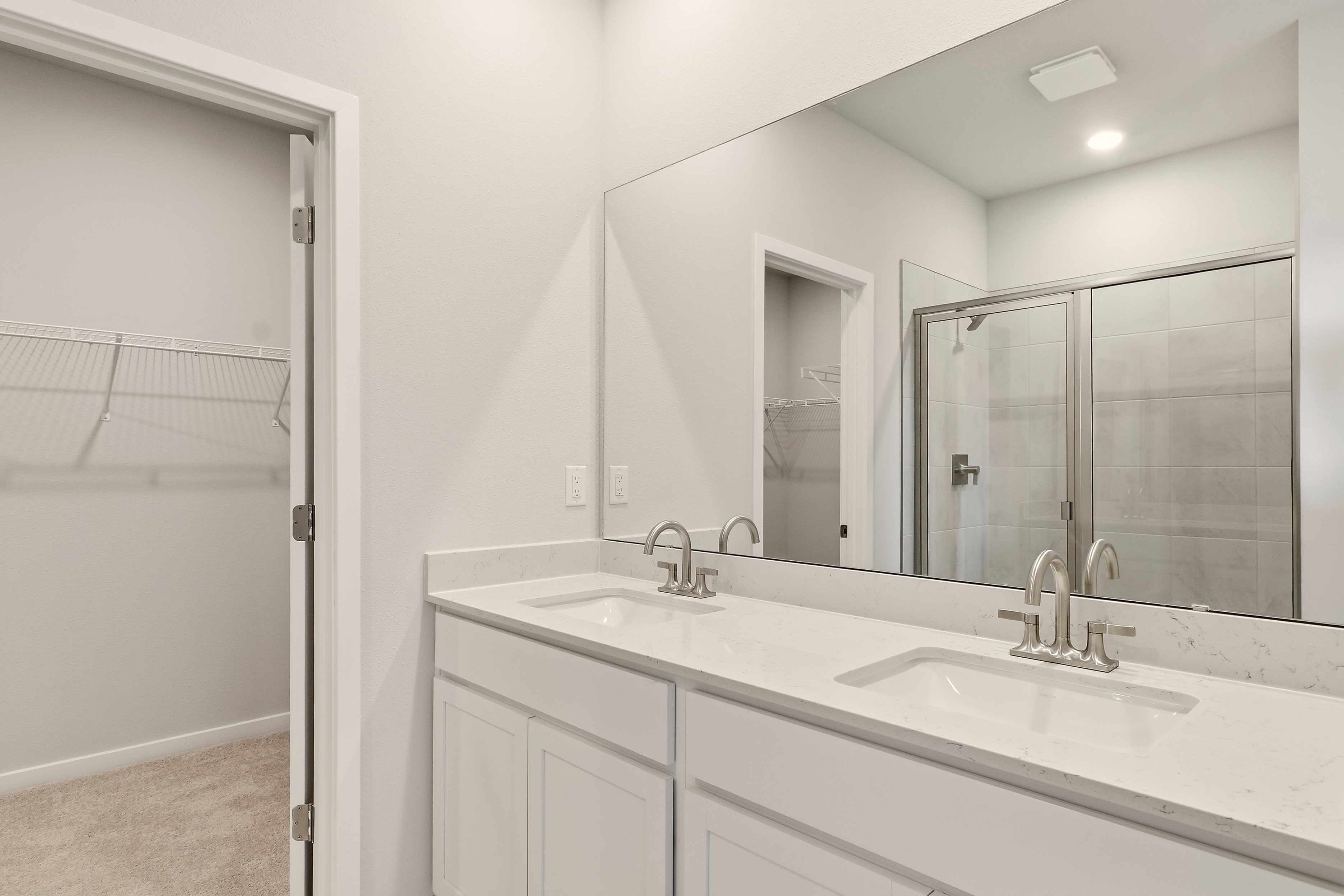 A bathroom with a large mirror.