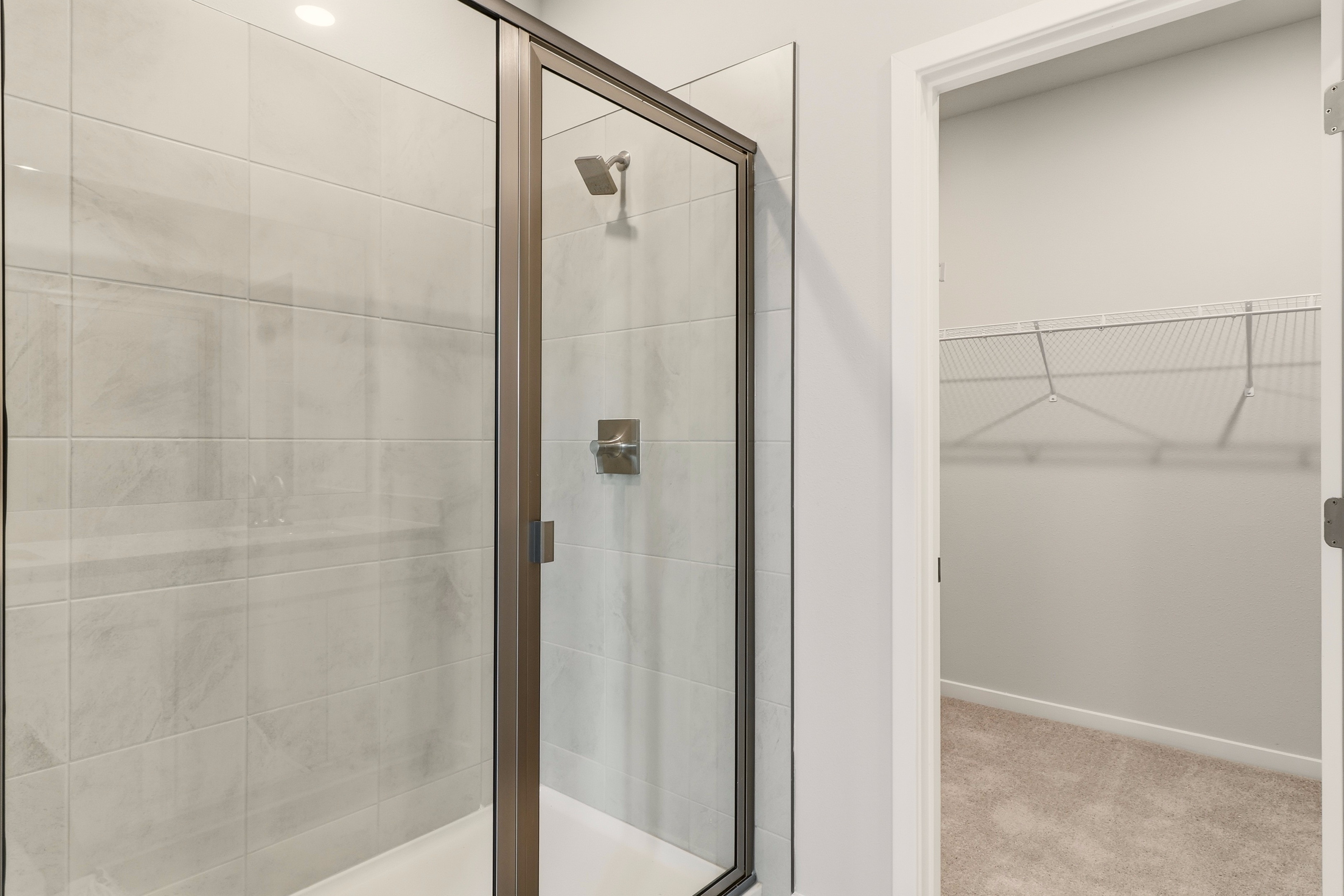 A shower with a glass door.