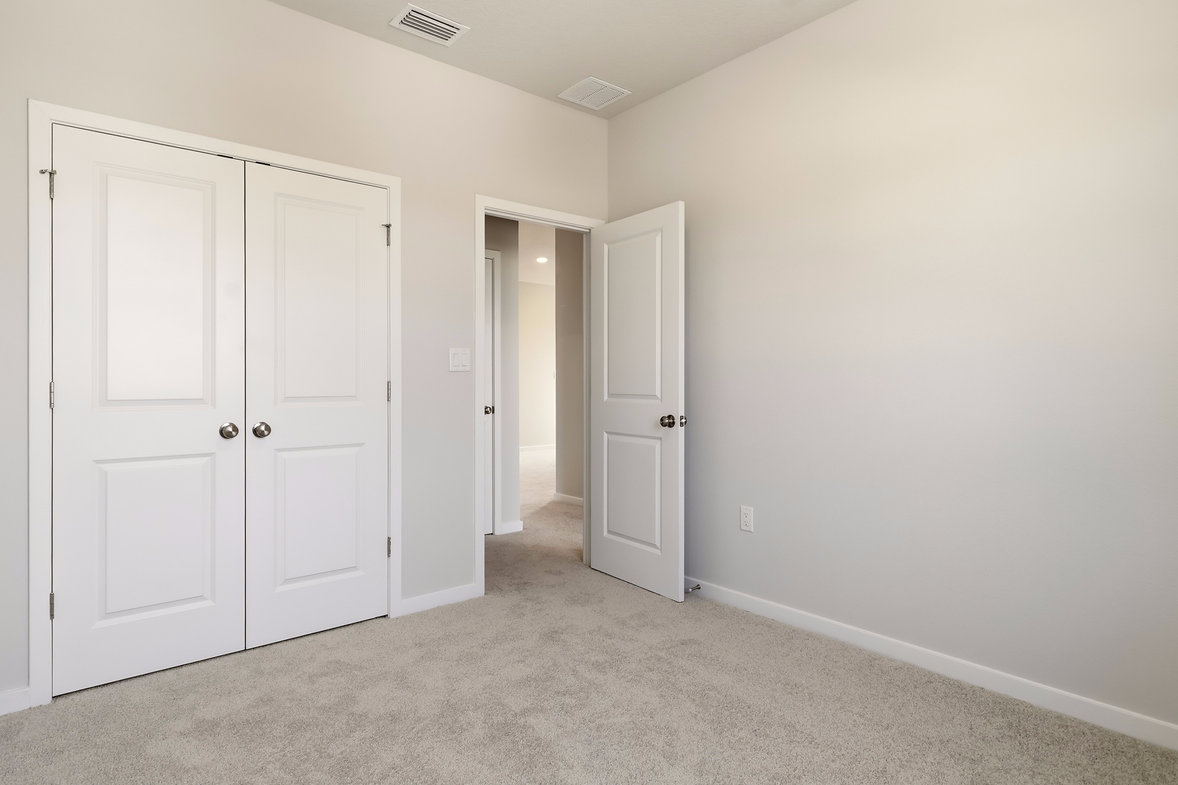 A hallway with white doors.