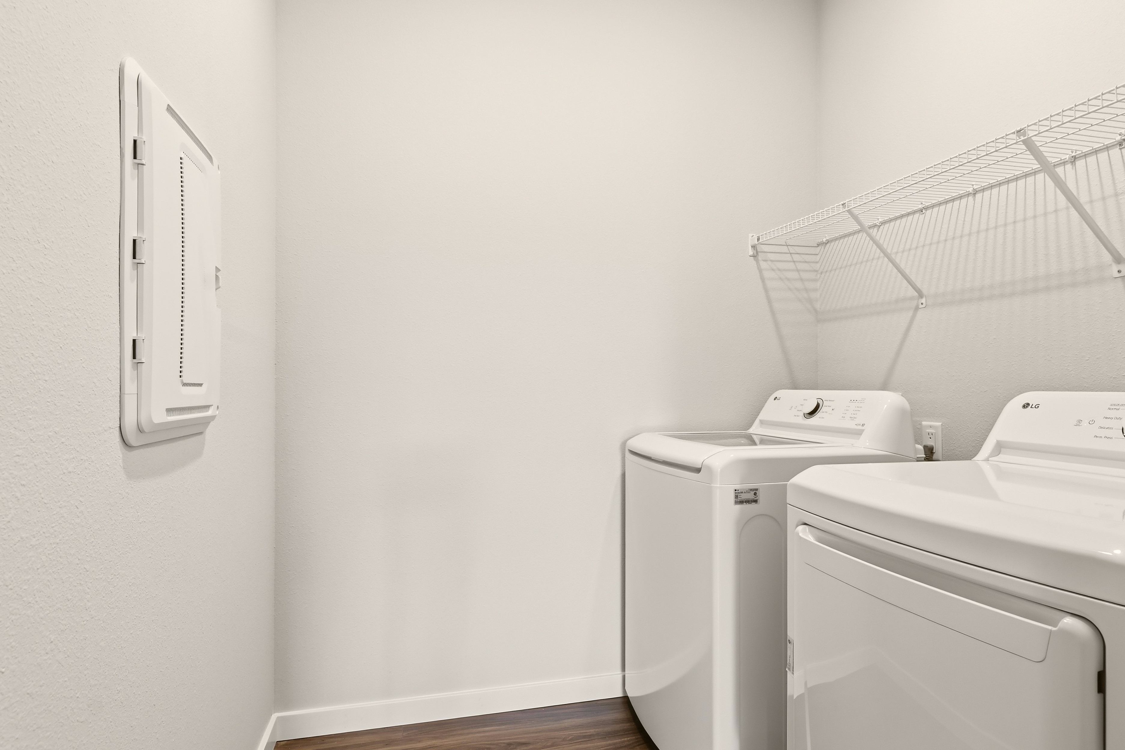 A washing machine and dryer in a room.