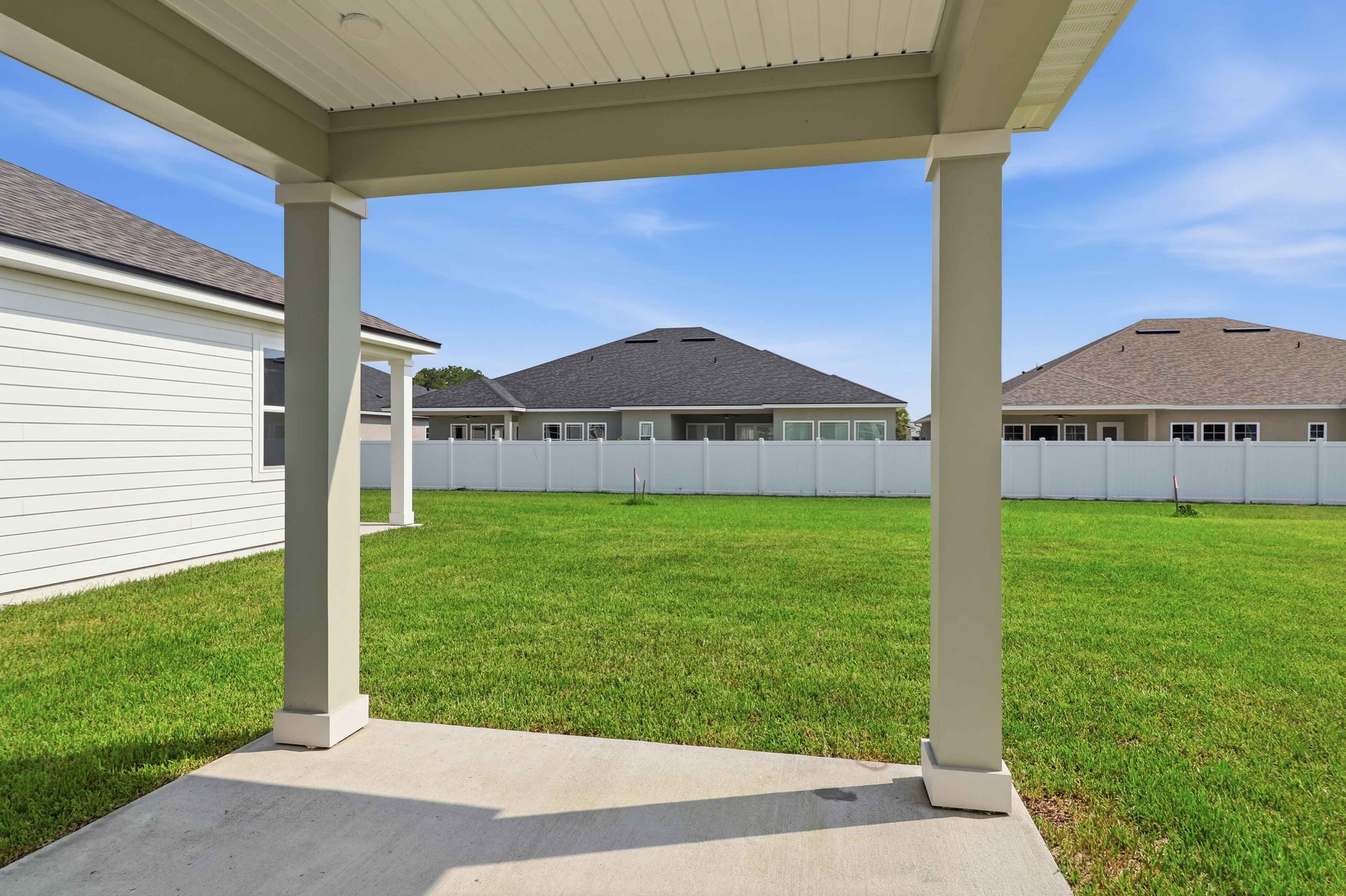 A building with pillars and grass.