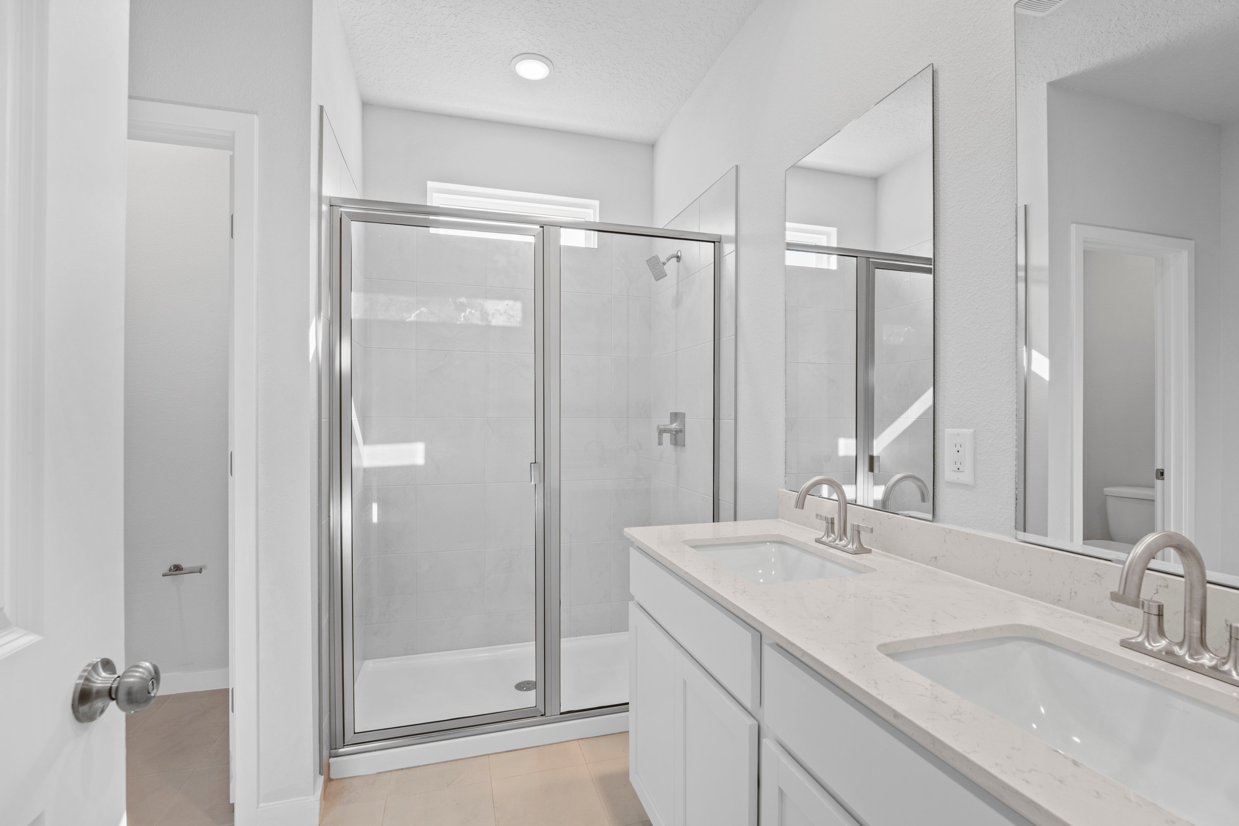 Lot 22 Primary Bath with Dual Vanity Sink and Walk-In Shower at Camden Woods in Kingsland