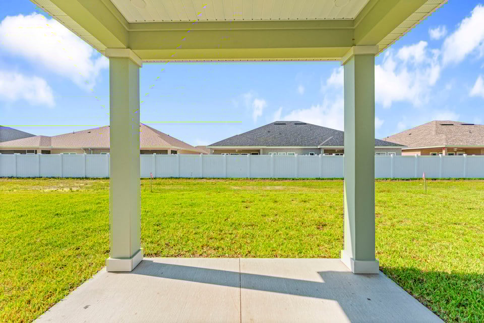 Lot 19 Cedar II Covered Patio with View of Backyard and Privacy Wall at Camden Woods in Kingsland, GA