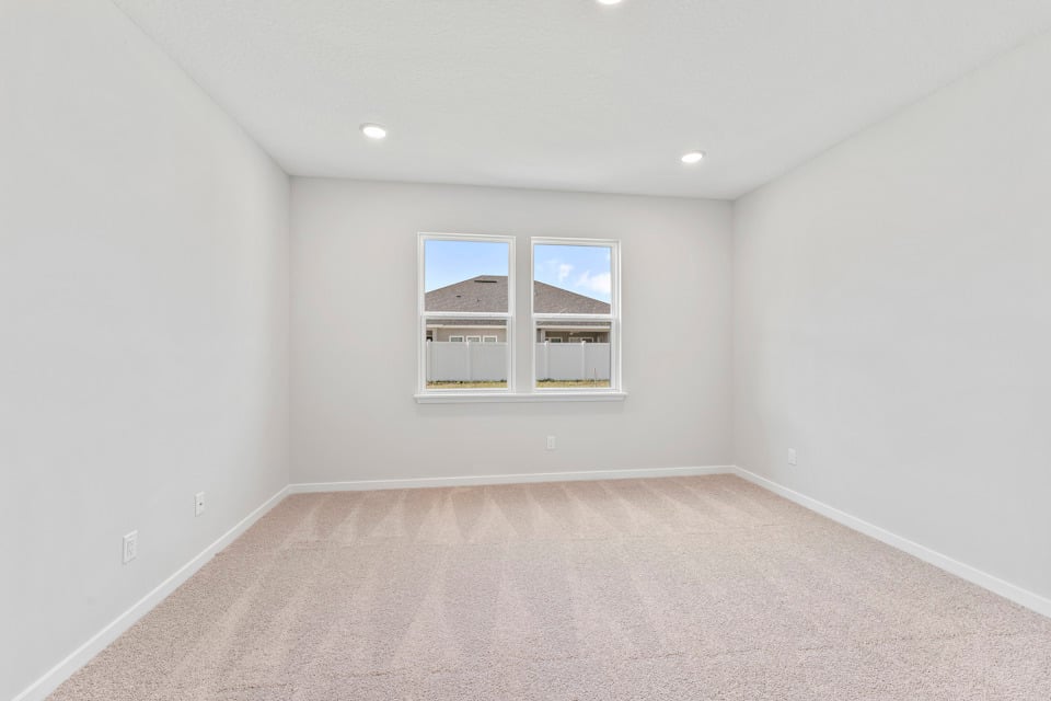 Primary Bedroom with Large Windows in Lot 19 Cedar II at Camden Woods in Kingsland, GA