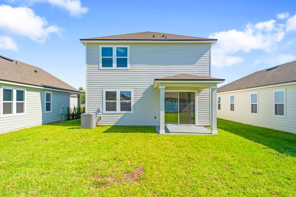 Lot 20 Ponderosa II Back Exterior of Home with Covered Patio at Camden Woods in Kingsland, GA
