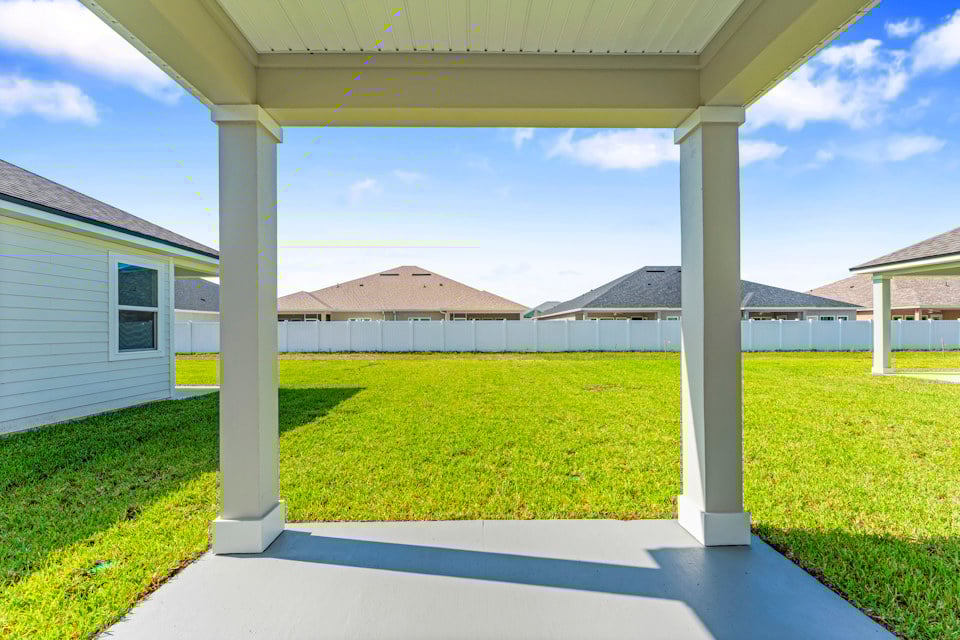 Lot 20 Ponderosa II Covered Patio with View of Backyard and Privacy Fence at Camden Woods in Kingsland, GA