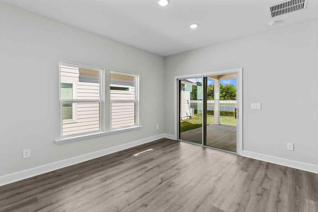A room with a wood floor and a glass door.