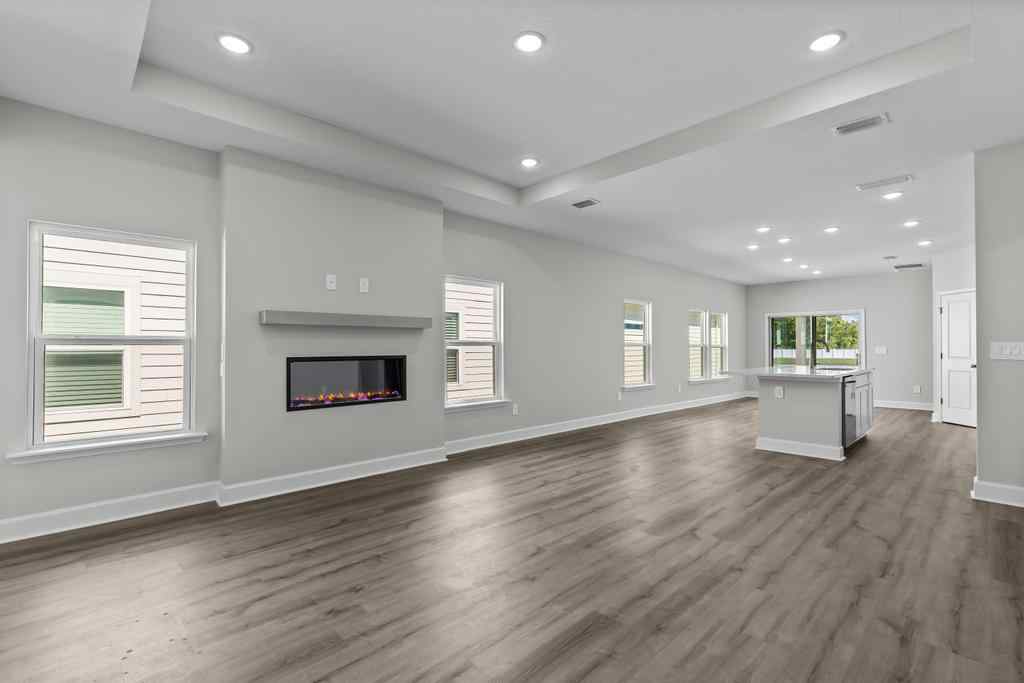 A large empty room with a fireplace.