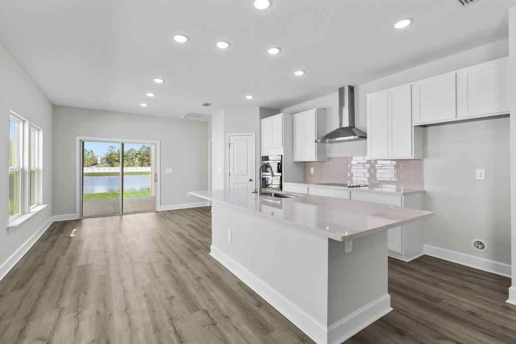 A kitchen with white cabinets.