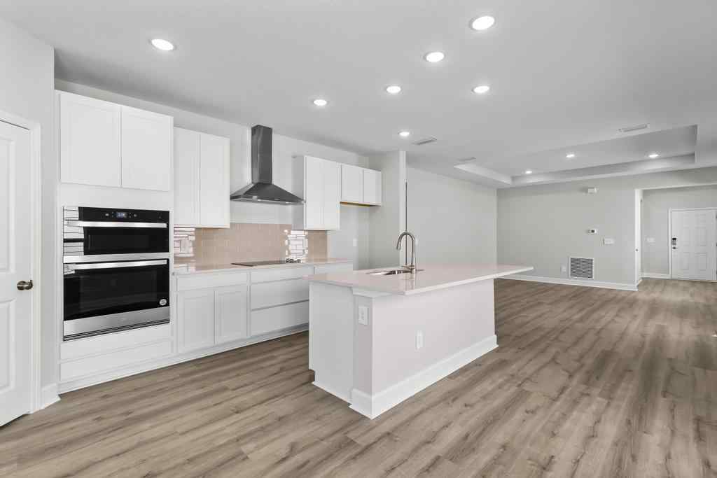 A kitchen with white cabinets.