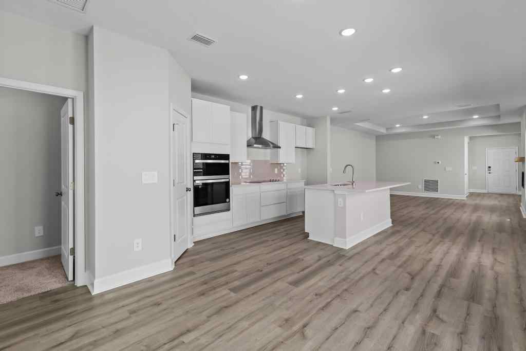 A kitchen with white cabinets.