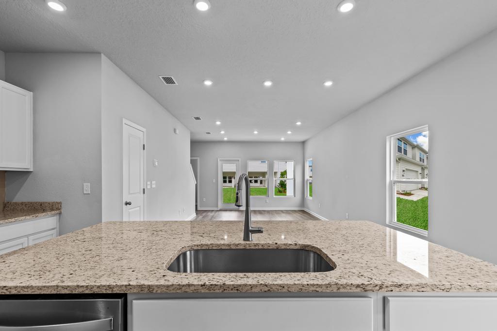 A kitchen with marble counters.