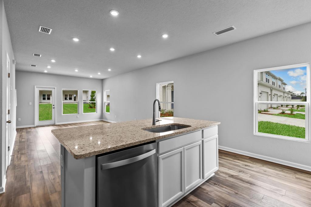 A kitchen with a marble counter top.