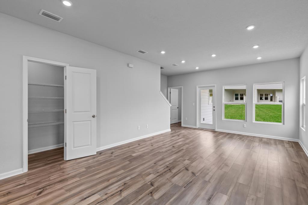 A room with white walls and wood floors.