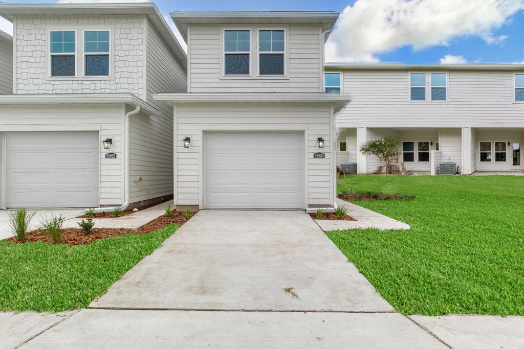 A driveway leading to a house.