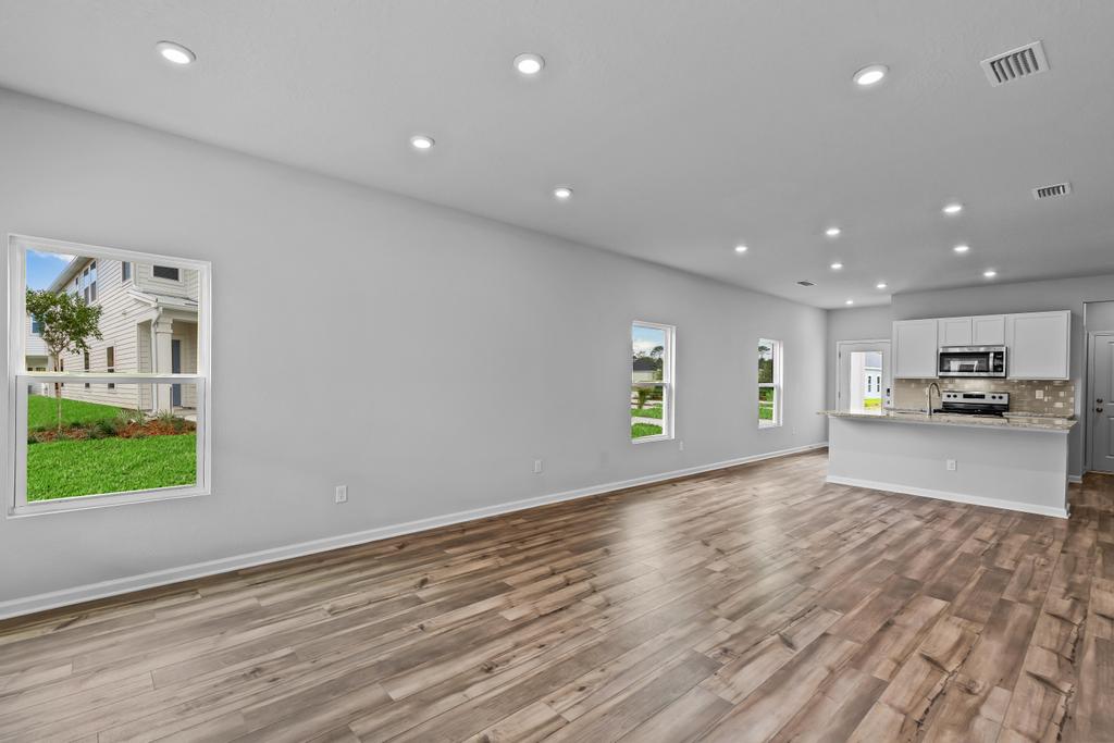 A kitchen with a wood floor.