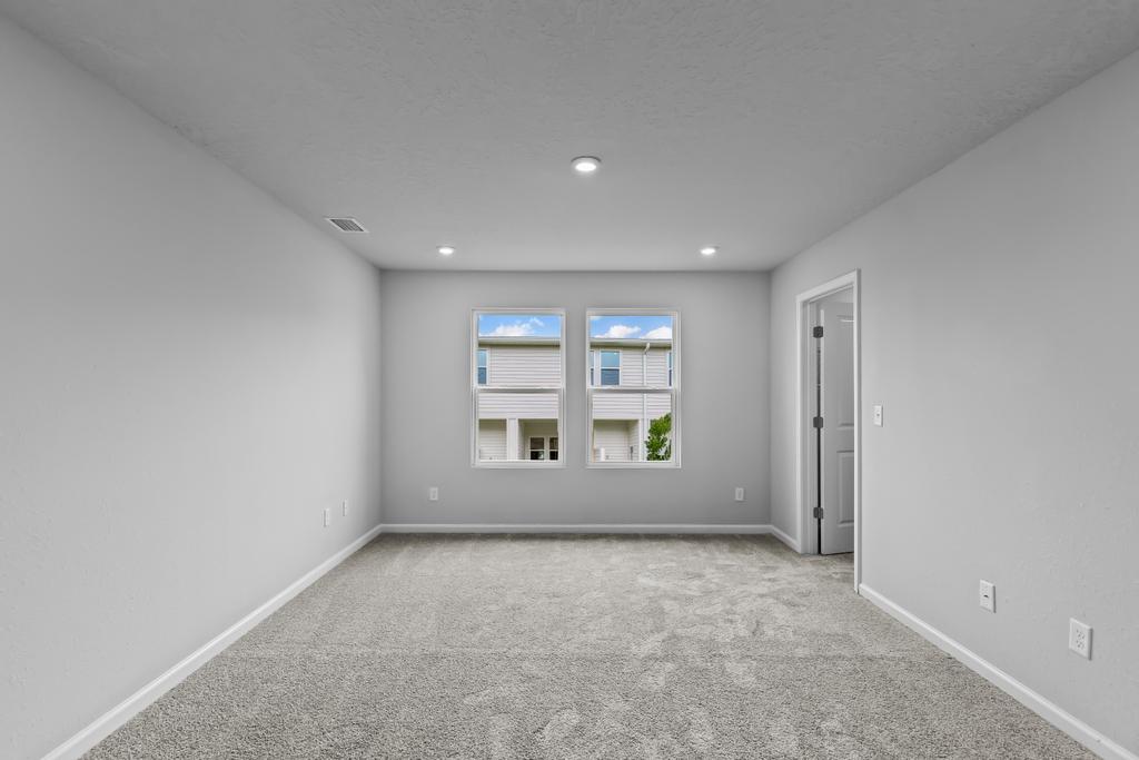 A room with a window and a carpet.