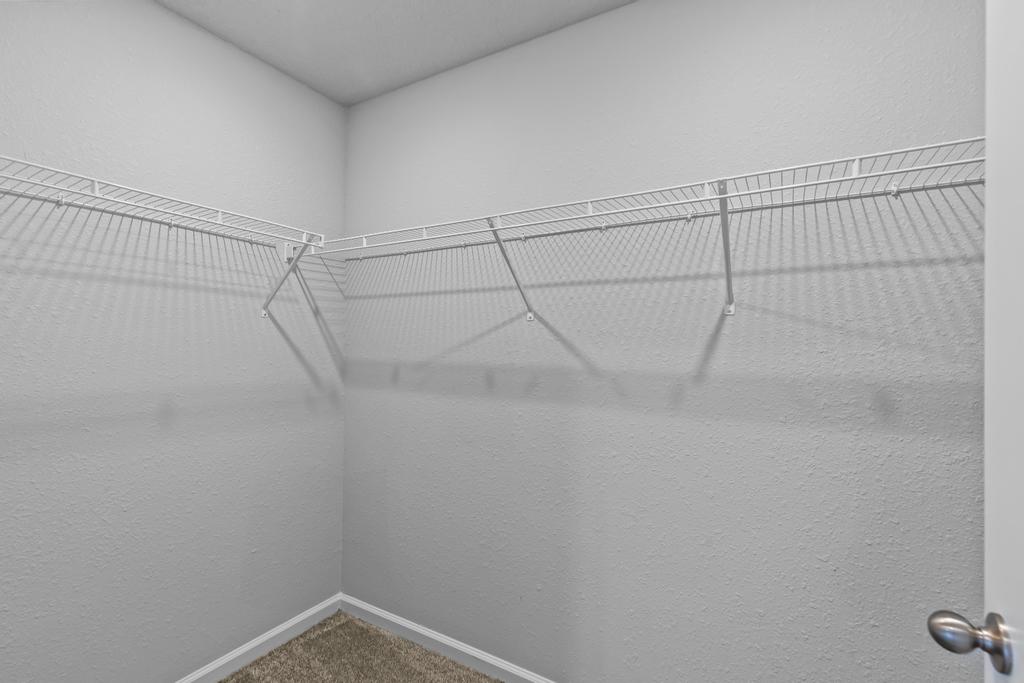 A white wall with a metal railing.