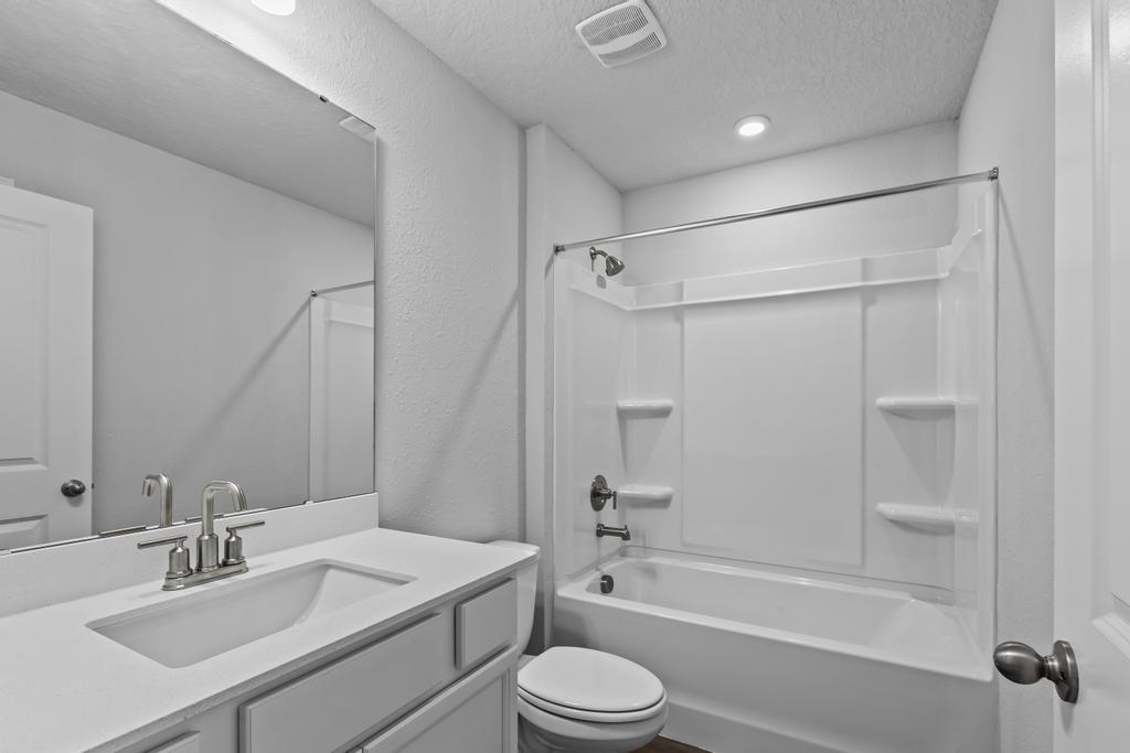 A bathroom with a sink toilet and shower.