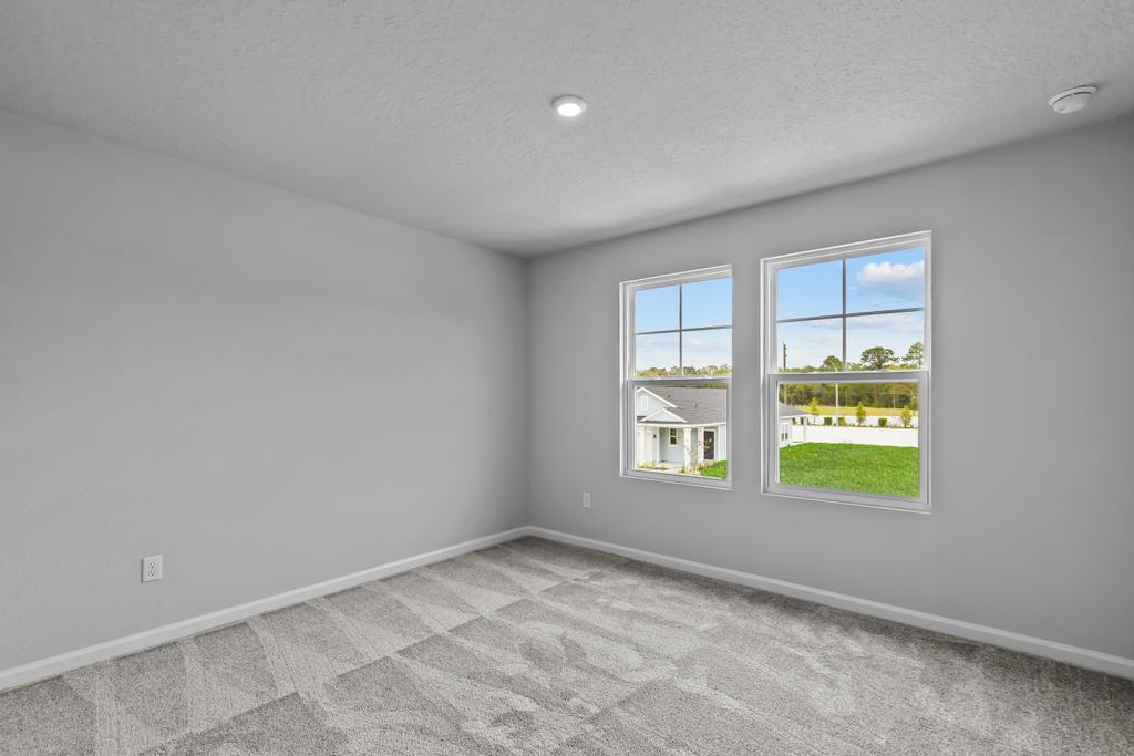 A room with windows and a tile floor.