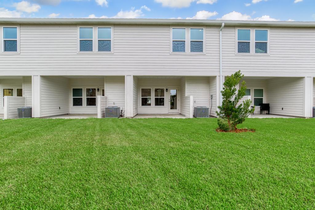 A house with a lawn in front.