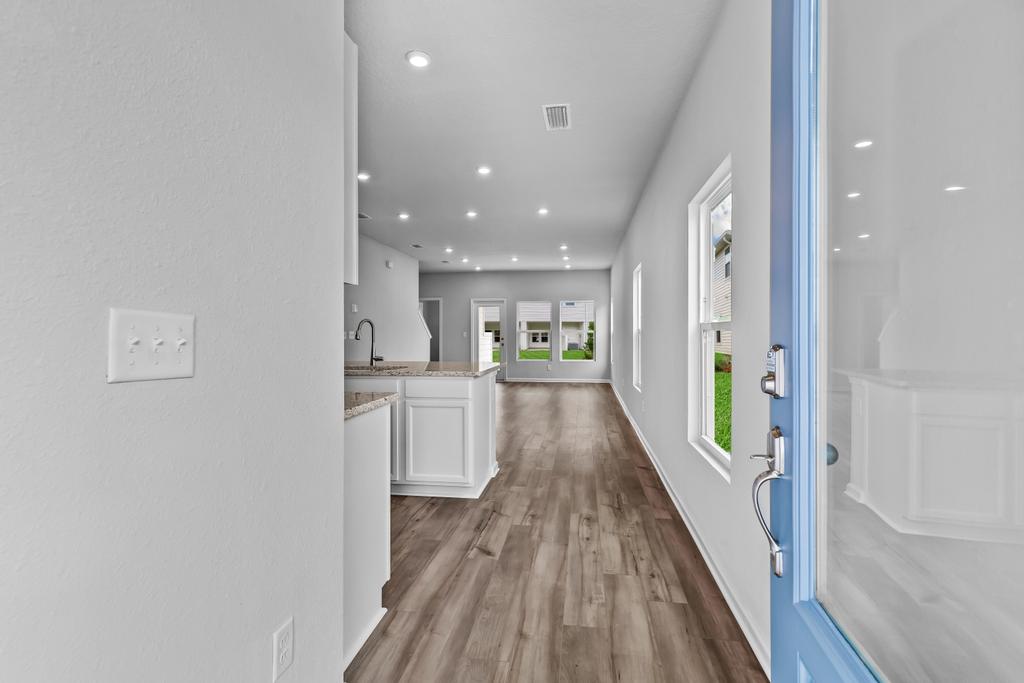 A long hallway with white walls.