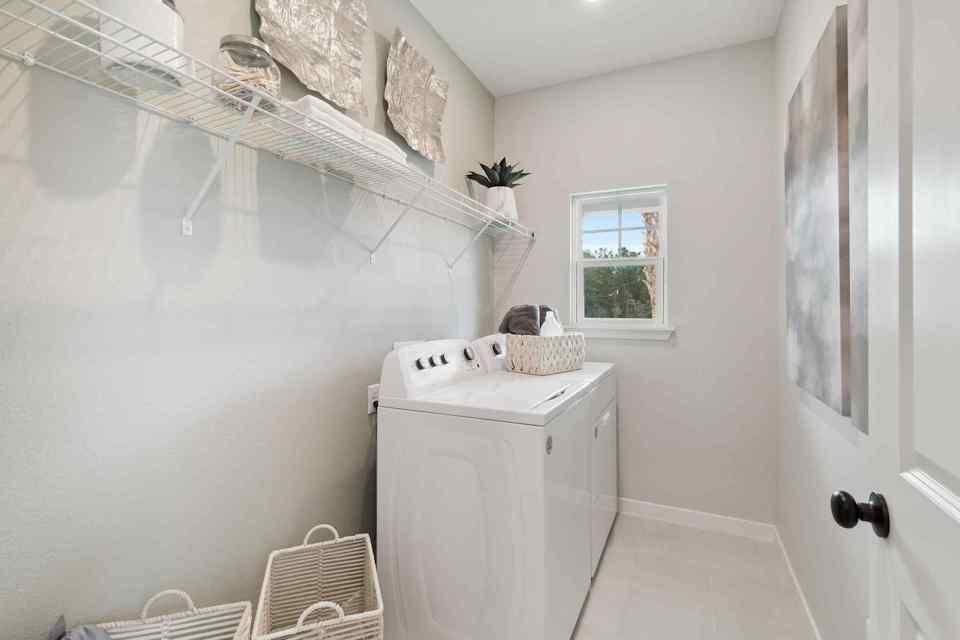 A white bathroom with a white shower curtain.