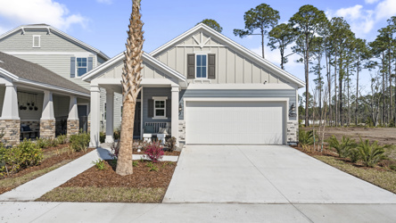 A white house with a garage.