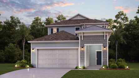 A house with a garage and trees.