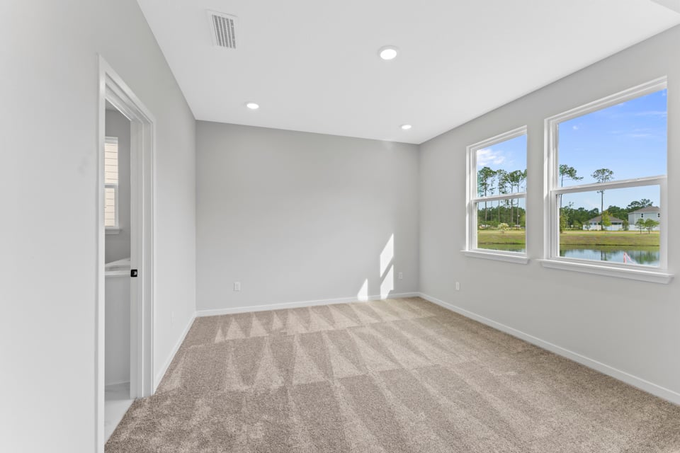 Miramar Floorplan Lot 81 Primary Bedroom with Large Windows at Concourse Crossing in Fernandina Beach