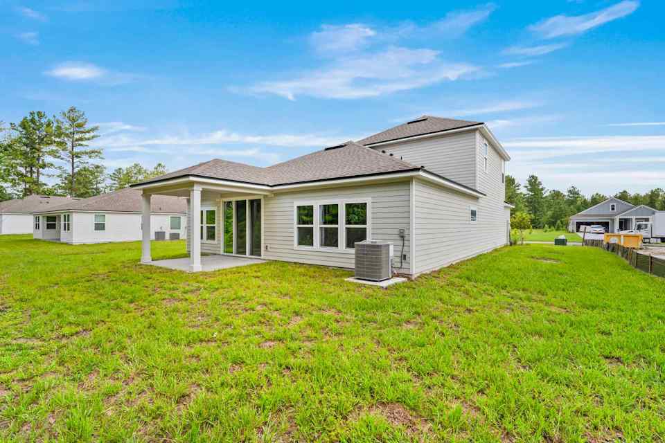 Dogwood Plan Lot 582 Rear Exterior with Covered Patio at NorthShore in Kingsland