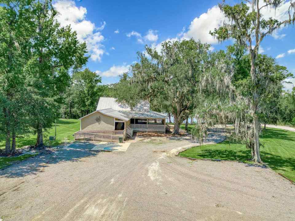 A dirt road leading to a building.