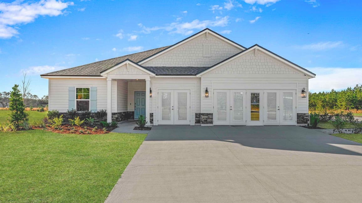 A white house with a driveway.